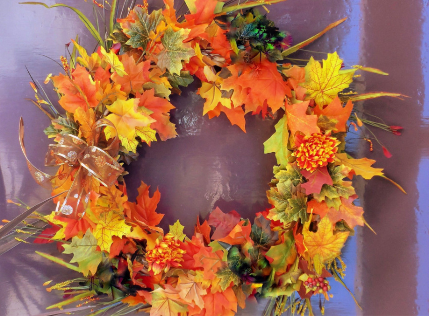 Use glue to attach flowers and leaves to your wreath! Source: The Spruce Crafts